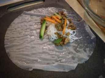 Rice paper with vermicelli, chicken, carrots and cucumbers.