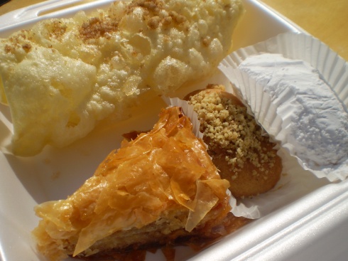 An array of desserts: diples $2.50, kourabiedes $1, Melomakarona $1 and Baklava $2.50 (clockwise from top).